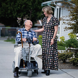 Elderly man in scooter with older daughter