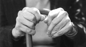 Closeup photo of hands holding a walking cane