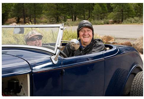 Senior driving in antique convertible