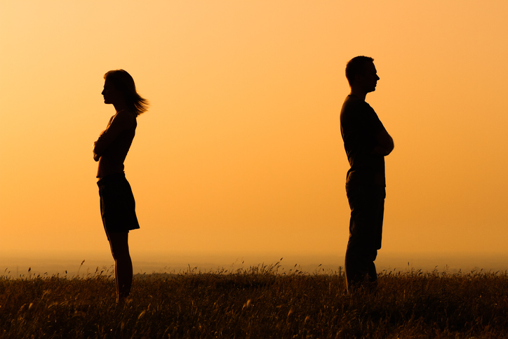 Silhouette of a angry woman and man on each other