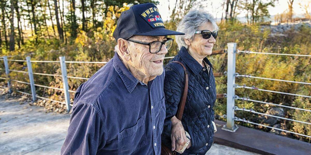 WWII vet walks with wife