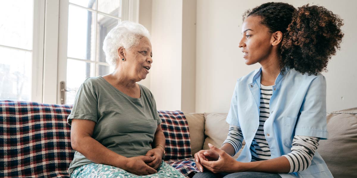 Caregiver talking to senior client