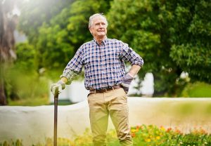 senior-man-with-cane-outside-gardening