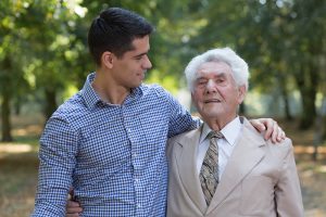caregiver outside with senior alzheimer's patient