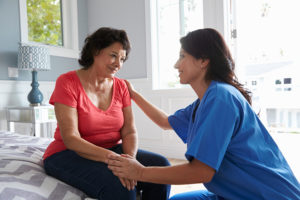 caregiver comforting senior with Alzheimer's