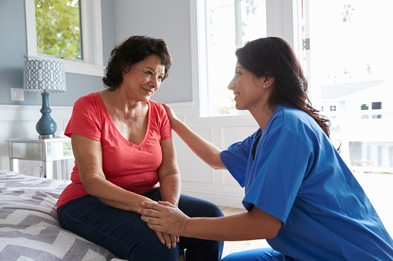 caregiver comforting senior with Alzheimer's