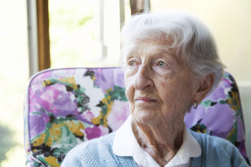 Senior woman looking out the window