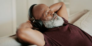 family caregiver listening to music to relieve stress