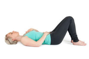 Woman doing yoga and breathing exercises