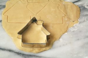 House shaped cookie cutter cutting cookies