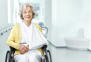 Senior woman in wheelchair and arm sling at the hospital, istockalypse Tokyo, Japan