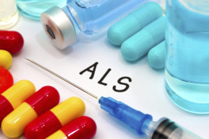 A syringe is surrounded by a variety of pills and vials of liquid, suggesting treatment options for ALS symptoms.