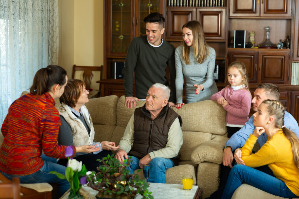 Family members sit in a circle discussing complicated family caregiving situations.