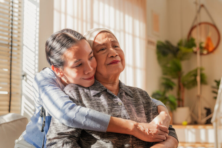 A woman receives a hug from her daughter after her cancer diagnosis.