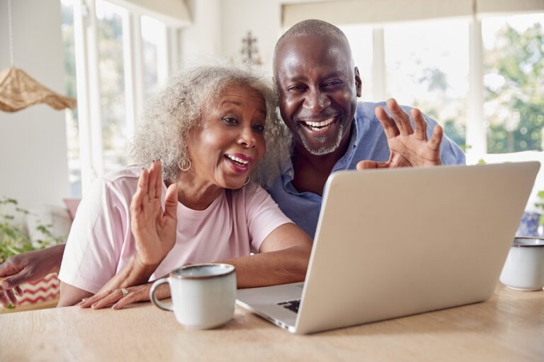Two older adults use tips for digital communication for seniors during a video chat.